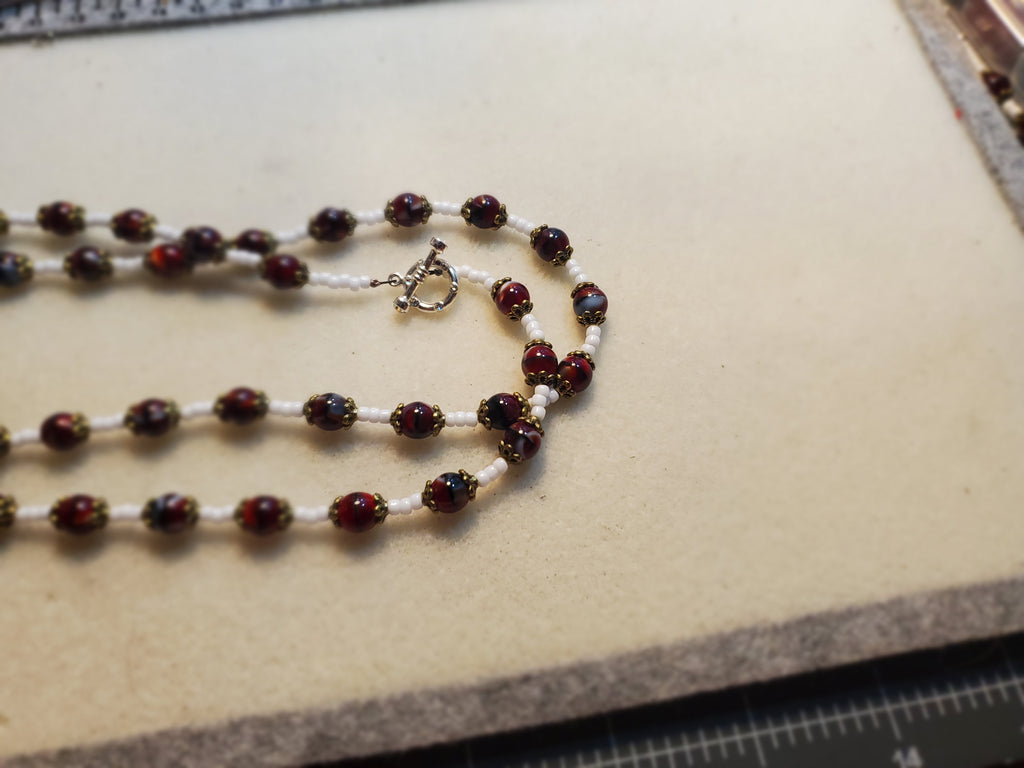 Dark red and white beaded necklace and bracelet set